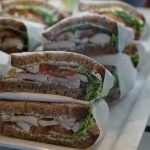 An image showcasing a vibrant underwater scene, with 15 distinct types of edible fish swimming gracefully amidst colorful coral reefs